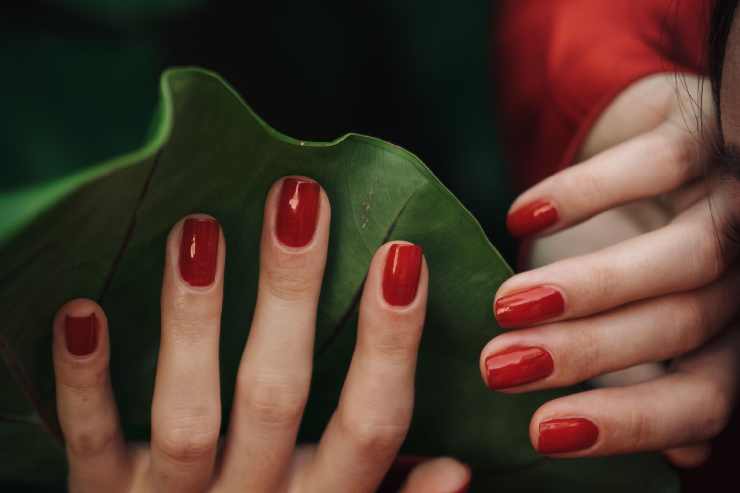 Manos con manicura y esmalte rojo